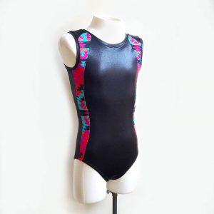 A black short-sleeved leotard with panels down the sides in a pink and blue aztec pattern